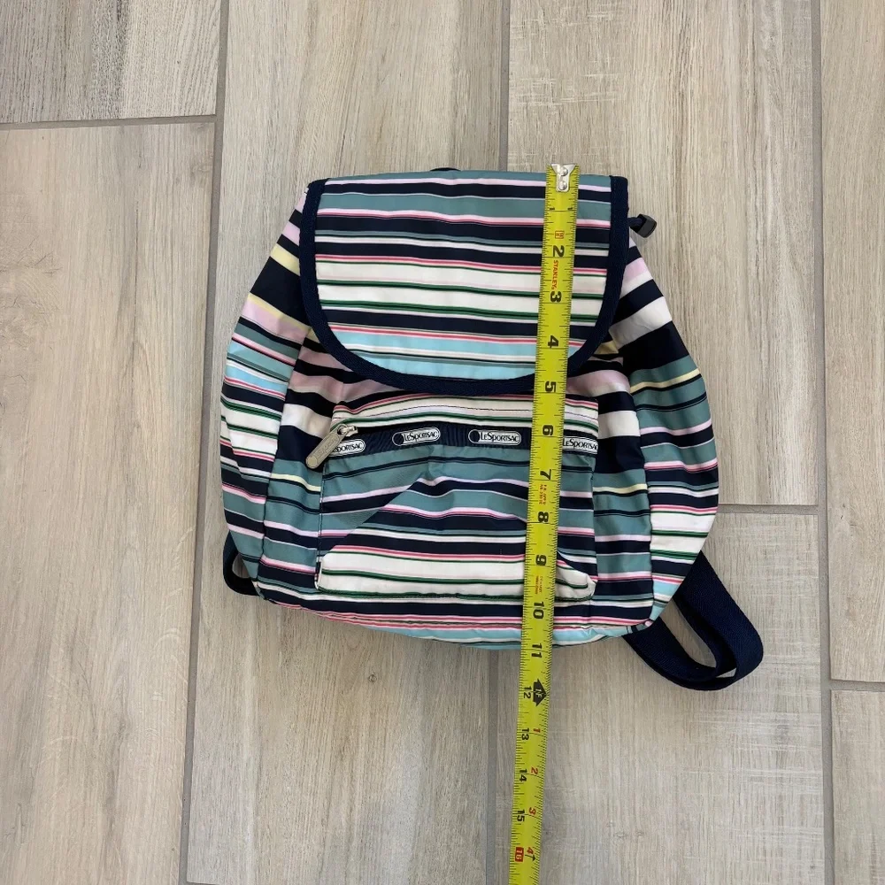 LeSportsac Voyager drawstring backpack in a navy pastel stripe pattern.